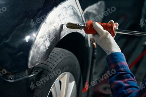 Preview: Mechanic working with front fender in tire fitting