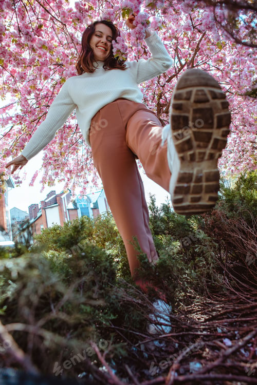 Preview: portrait of beautiful caucasian woman with blooming sakura cherry trees