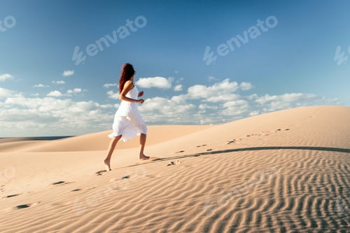 Preview: Girl in a white dress running on the sand