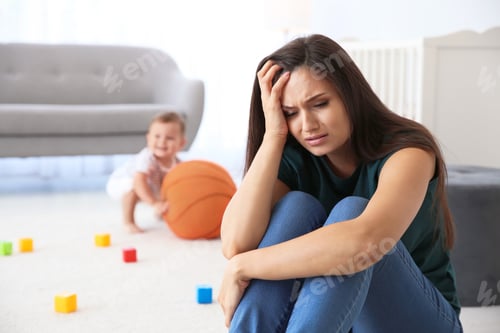 Preview: Young mother suffering from postnatal depression and little baby in room