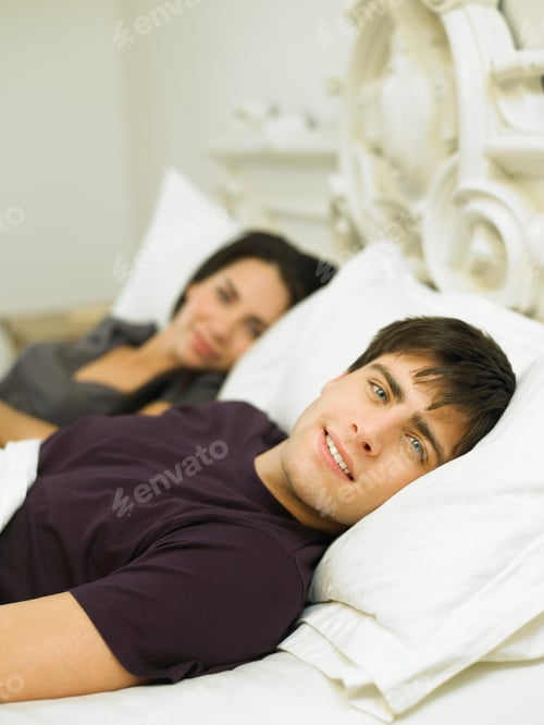 Preview: Young couple lying in bed