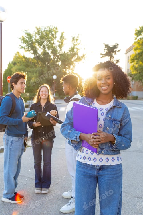 Preview: Diverse university students smiling on campus during sunset