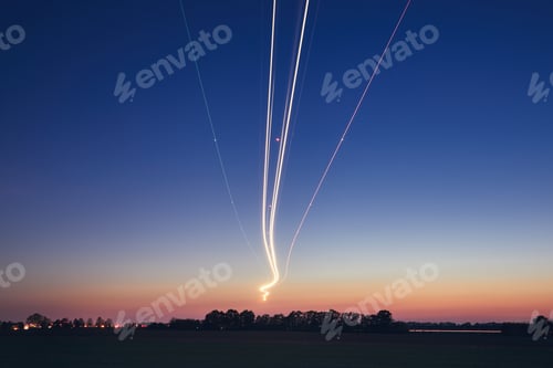 Preview: Light trails of airplane during landing at airport after sunset. Prague, Czech Republic.