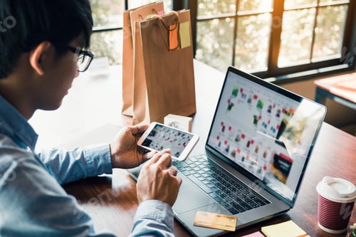 Preview: Hands of man are holding smart phones and using laptops computers are entering websites