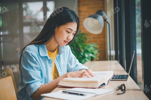 Preview: Asian teenage students taking online distance learning on laptop, in cafe