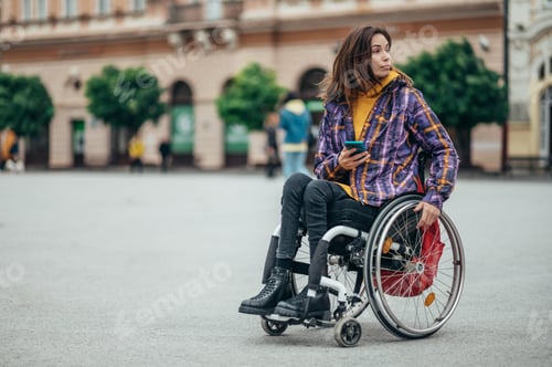 Preview: Woman with disability using a smartphone while out in the city