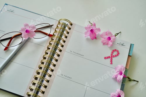 Preview: A planner opened to October and a pink ribbon for breast cancer awareness month.