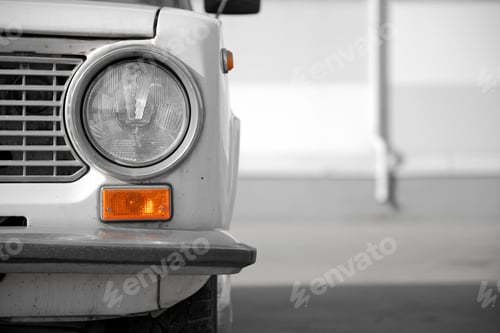 Preview: Retro car front close up. Round headlight