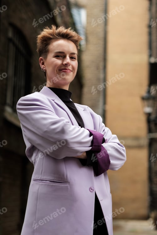 Preview: Confident young woman looking at camera in an old London street.