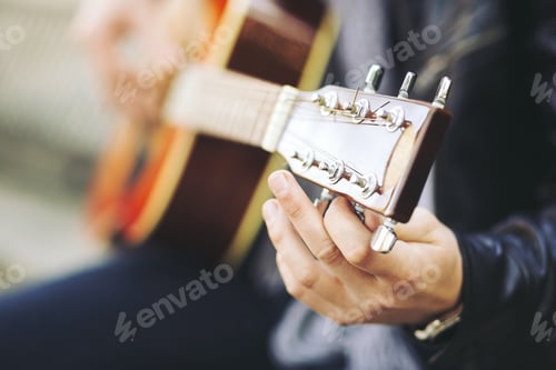 Preview: Young attractive street artist with his guitar