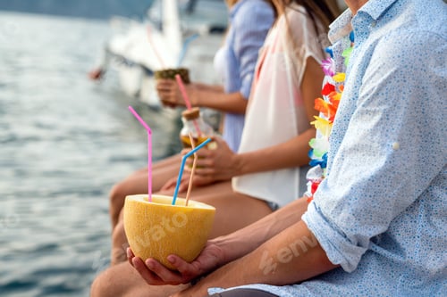 Preview: Happy friends having fun with tropical cocktails on beach party. Travel and summer vacation concept.
