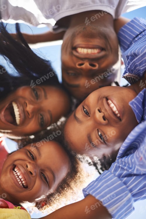 Vista previa: Low view portrait of a happy african-american family spending the day at the beach together