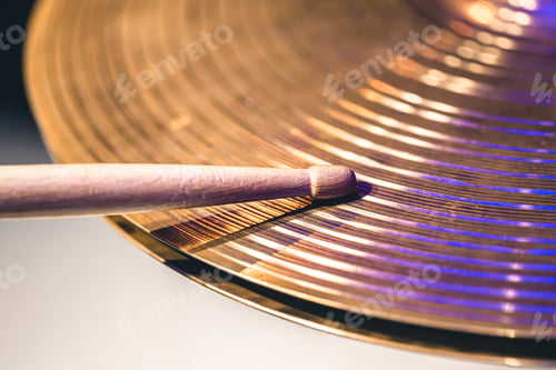 Preview: Close-up of drumsticks on a cymbal drum.
