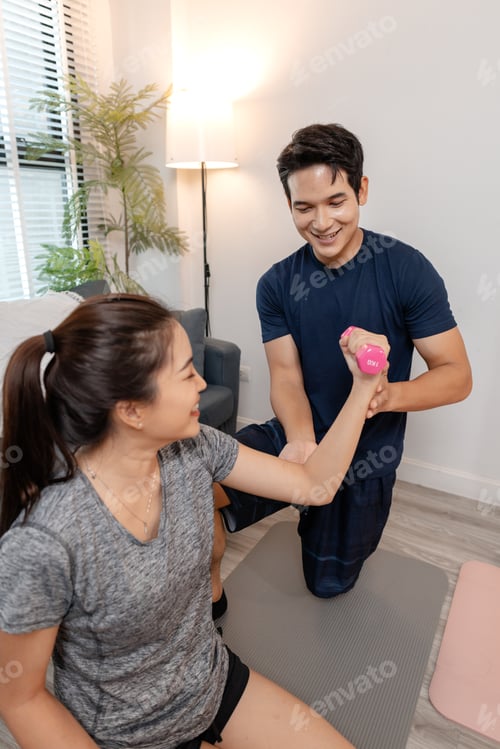 Preview: A young couple exercising together at home, smiling and enjoying their workout routine.