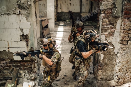 Preview: Top view of air soft team with rifles shooting at ruined building.