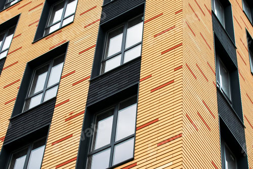 Preview: The wall of a brick multistoried building with transparent windows. Geometric abstract pattern.