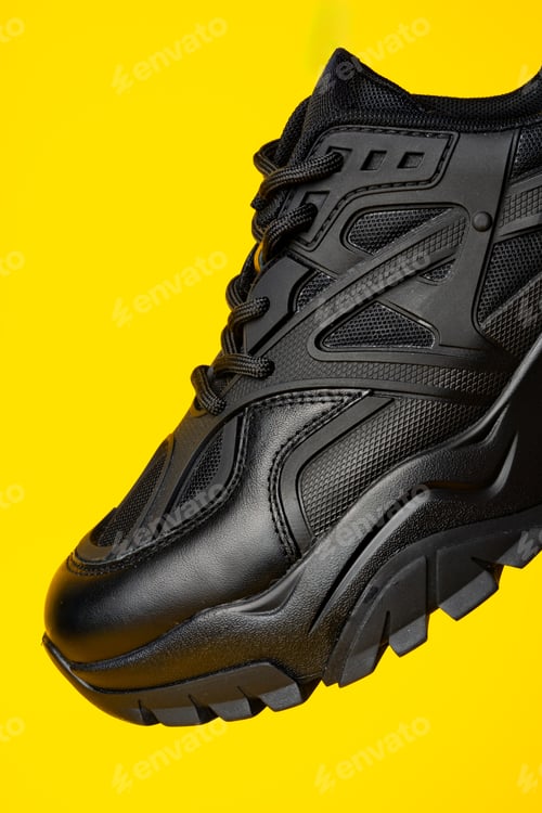 Preview: Black new sport sneakers on yellow background