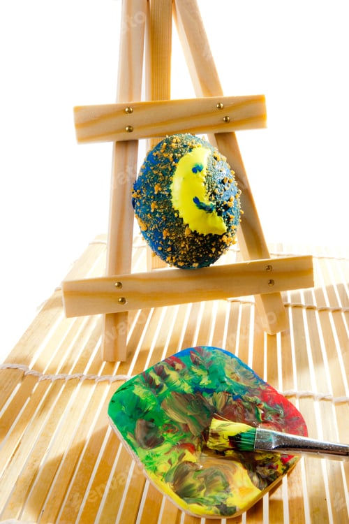 Preview: Painting easter eggs in workshop on the white background