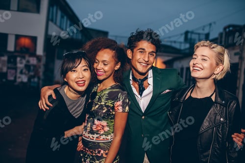 Preview: Group of friends walking on city street together at night