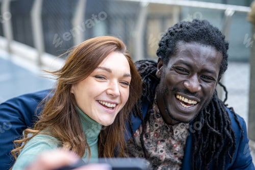 happiness moment of a milturacial couple in love, selfie time for two friends