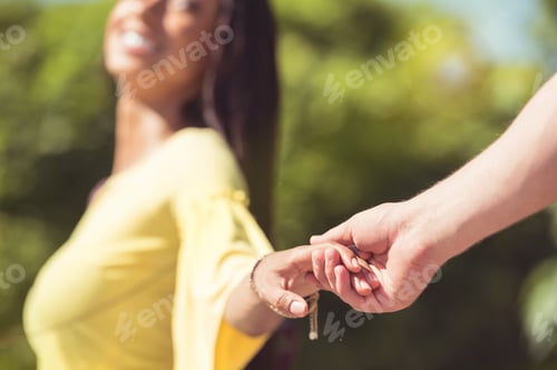 Preview: close up view of young happy couple holding hands