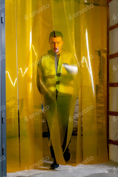 Preview: A waste recycling station employee walks through silicone curtain in the plant's doorway