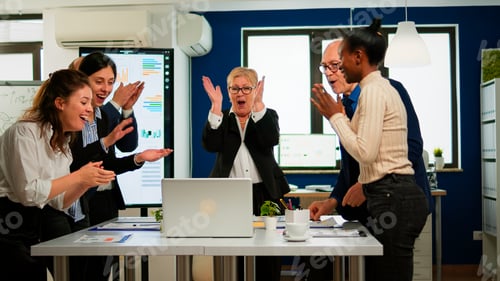 Preview: Happy creative business team having meeting in broadroom office