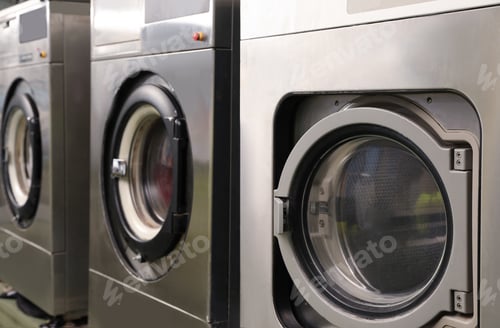 Preview: Row of modern washing machines in dry-cleaning, closeup
