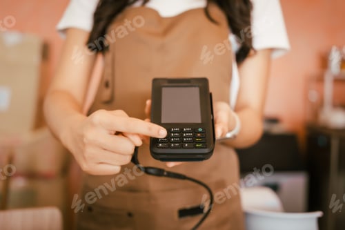 Preview: A beautiful young woman barista smiling warmly while making fresh coffee in a cozy café, creating
