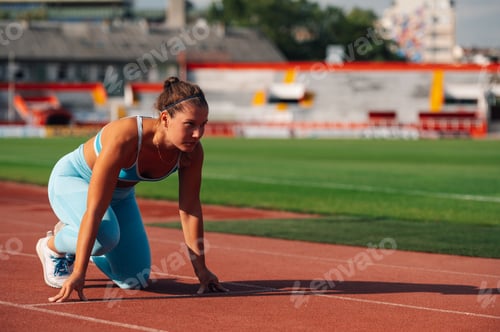 Preview: Female runner getting ready to start a race at the stadium