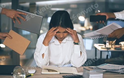 Preview: Shot of a young businesswoman suffering from a headache in a demanding work environment