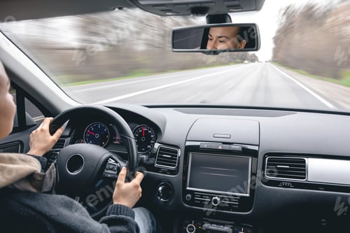 Preview: Woman driver's hands on a car steering wheel.