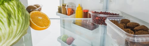 Preview: Fresh fruits, cutlets and sauces in fridge with open door isolated on white, panoramic shot