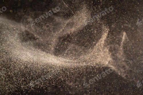 Preview: Organic dust particles floating on a light beam on black background.