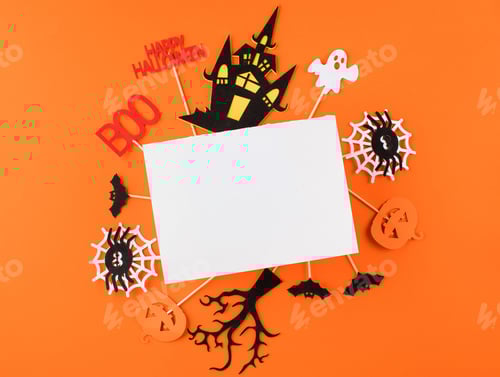 Preview: Halloween greeting card with funny holiday symbols and blank paper on orange