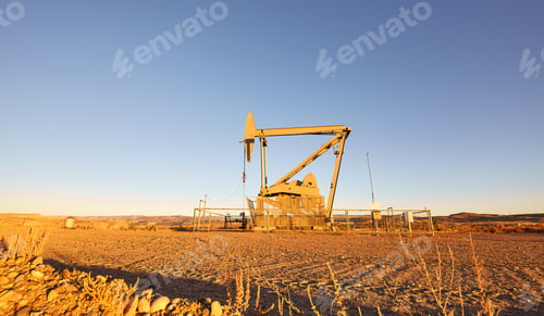 Preview: Pump jack (nodding donkey) on a desert at sunset.