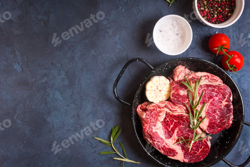 Preview: Raw meat steak on rustic concrete background ready to roasting