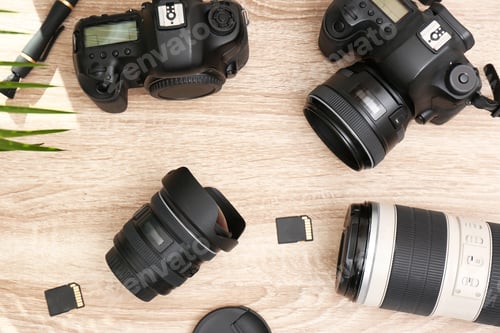 Preview: Professional photographer's equipment on wooden table, top view