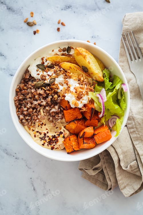 Preview: Vegetarian buddha bowl with buckwheat, cottage cheese, hummus and baked potatoes.