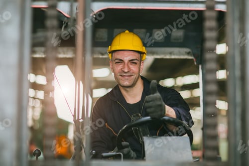 Preview: Portrait happy forklift driver wearing safety helmet and vest enjoy working transporting goods in wa