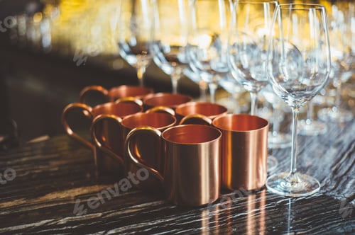 Preview: Brass cups and glasses on table