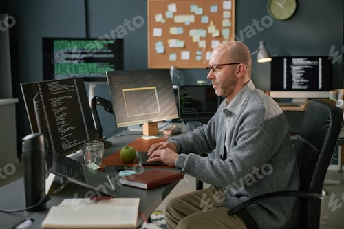 Preview: Middle Aged Caucasian Man Developing Software Application in Contemporary Workspace