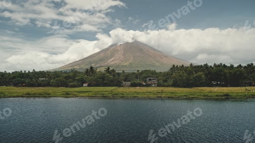 Preview: Volcano erupt at green lake shore aerial. Philippines coutryside of Legazpi town at greenery meadows