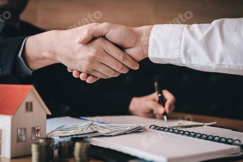 Preview: Home sales agents and buyers work on signing new homes and shaking hands.