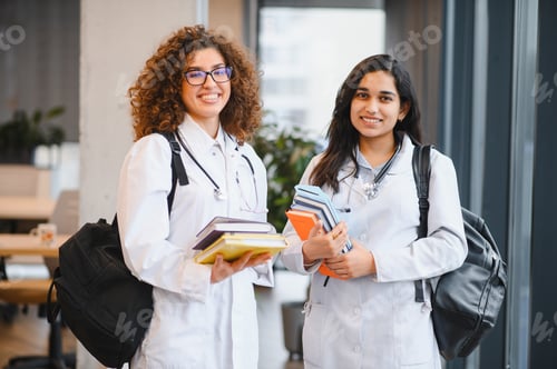 Preview: Medical students carrying books at university campus