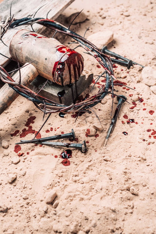 Preview: Old wooden cross, hammer, bloody nails and crown of thorns on ground. Banner. Copy space. Good