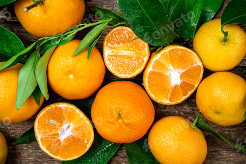 Preview: Tangerine, mandarines, clementine, citrus fruits with leaves on wooden background