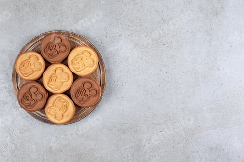Preview: Appetizing bundle of cookies on wooden board on marble background