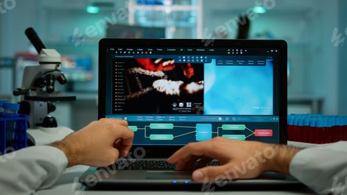 Preview: Pov shot of biochemist analysing vaccine evolution on laptop sitting