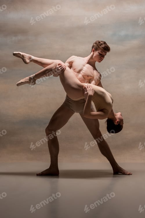 Preview: Couple of ballet dancers posing over gray background